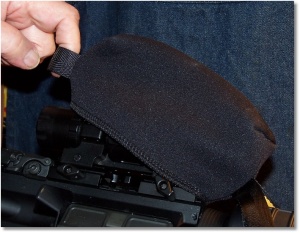 Pull the Rear Tab of the Scopeshield to Take It Off or to Put It On.
